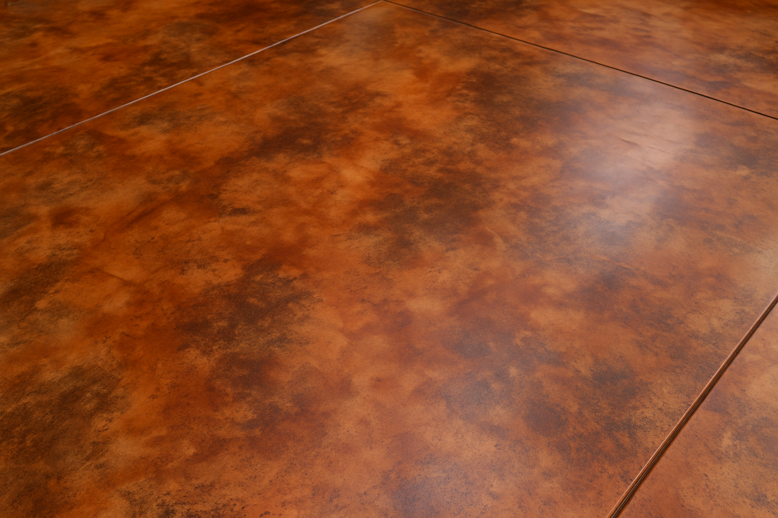 Close-up of acid-stained concrete patio floor with mottled terracotta tones